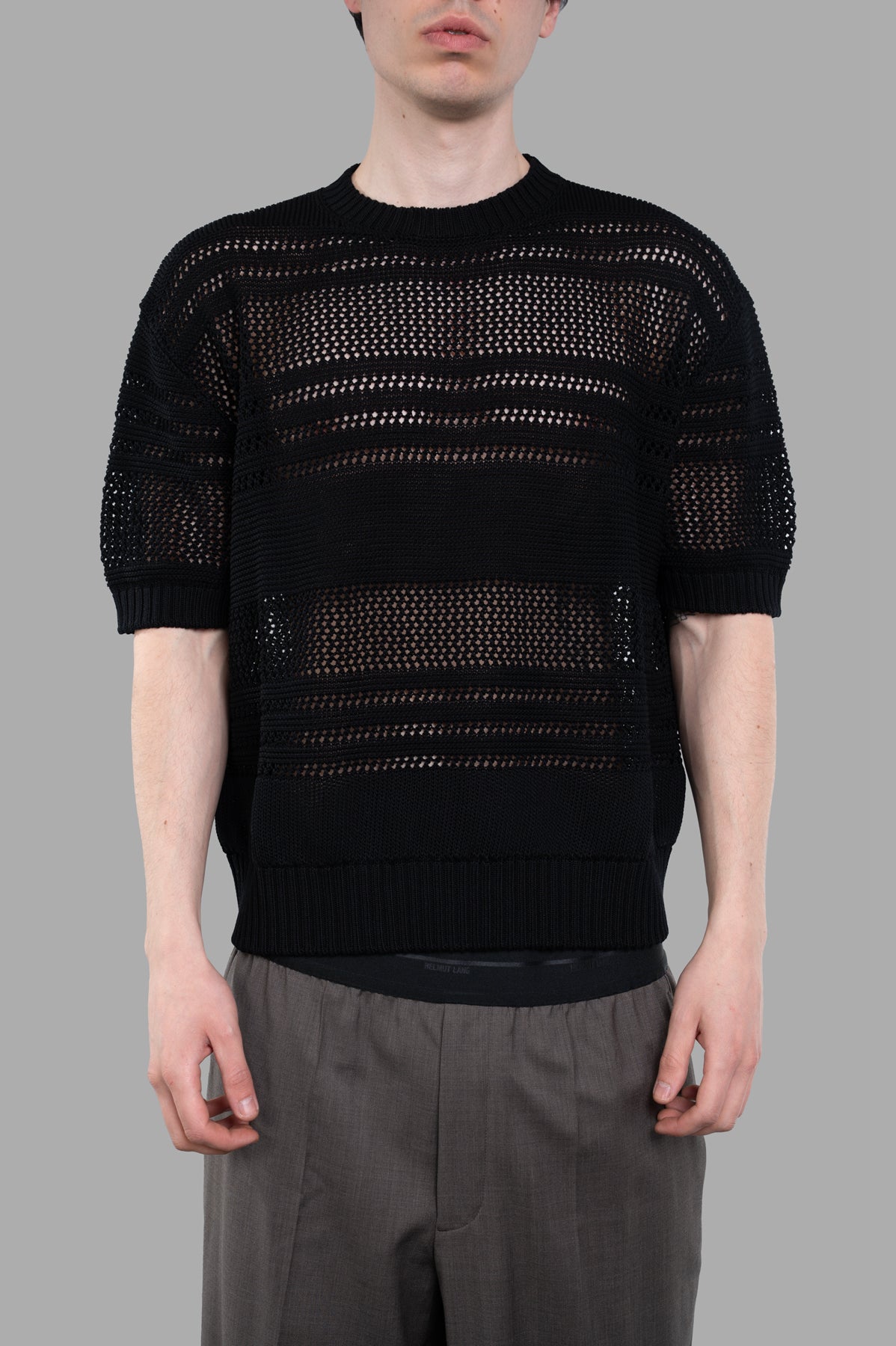 AION Perforated-mesh T-shirt in black, featuring a close-up view of the short-sleeved design and breathable texture.