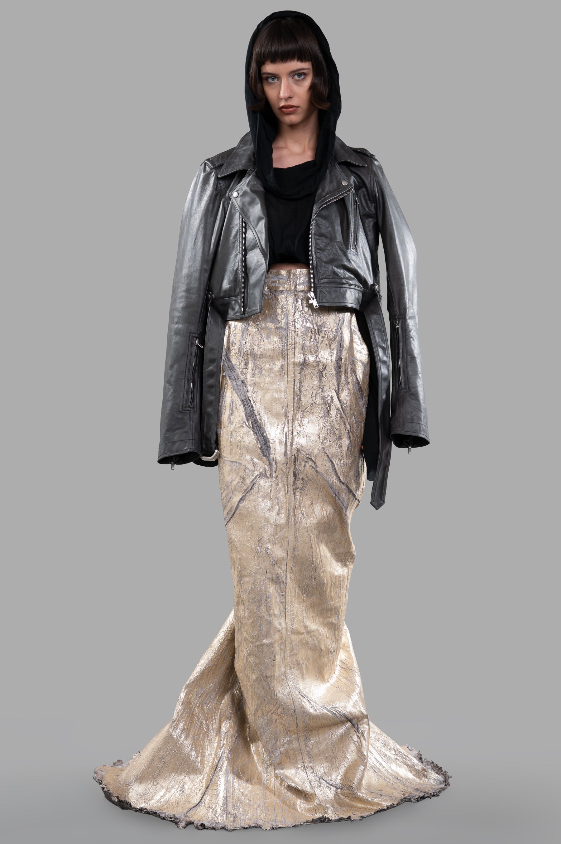 Rick Owens Lido Maxi Skirt in gold, front view. Features sheen finish, inset pockets, worn with leather jacket.