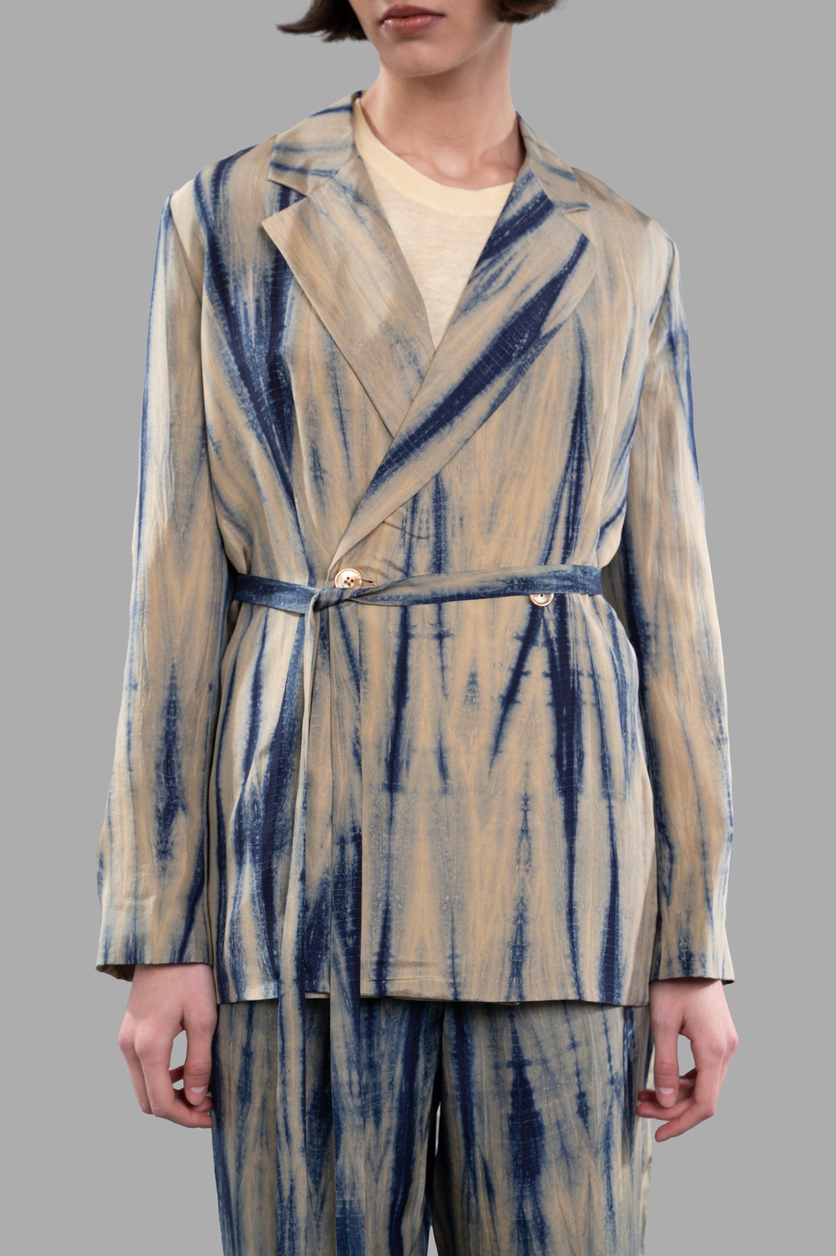 Joseph. Tie-dye Silk Jacket featuring a close-up of the double-breasted front and unique sand/navy pattern on model.