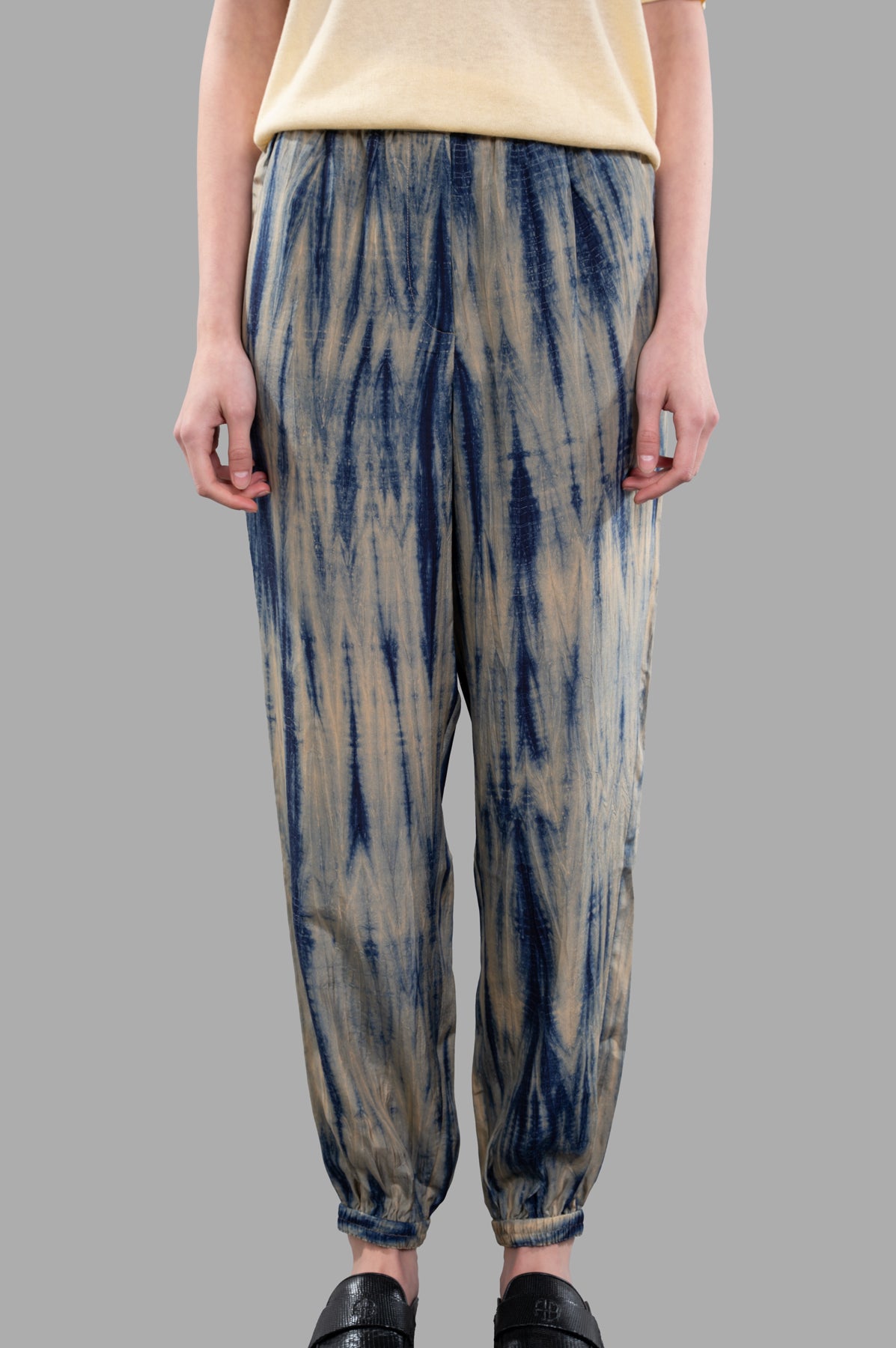 Joseph Tie-dye Silk Trousers in sand and navy; relaxed-fit jogger style with unique Japanese tie-dye pattern on model.