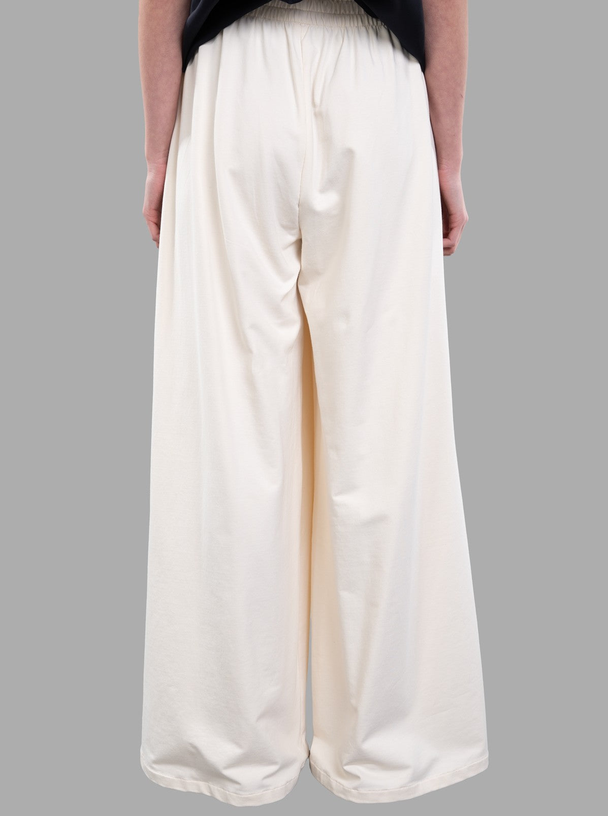 Norma Kamali Wide-leg Trousers shown from the back in ecru, featuring an elasticized waist for comfort.
