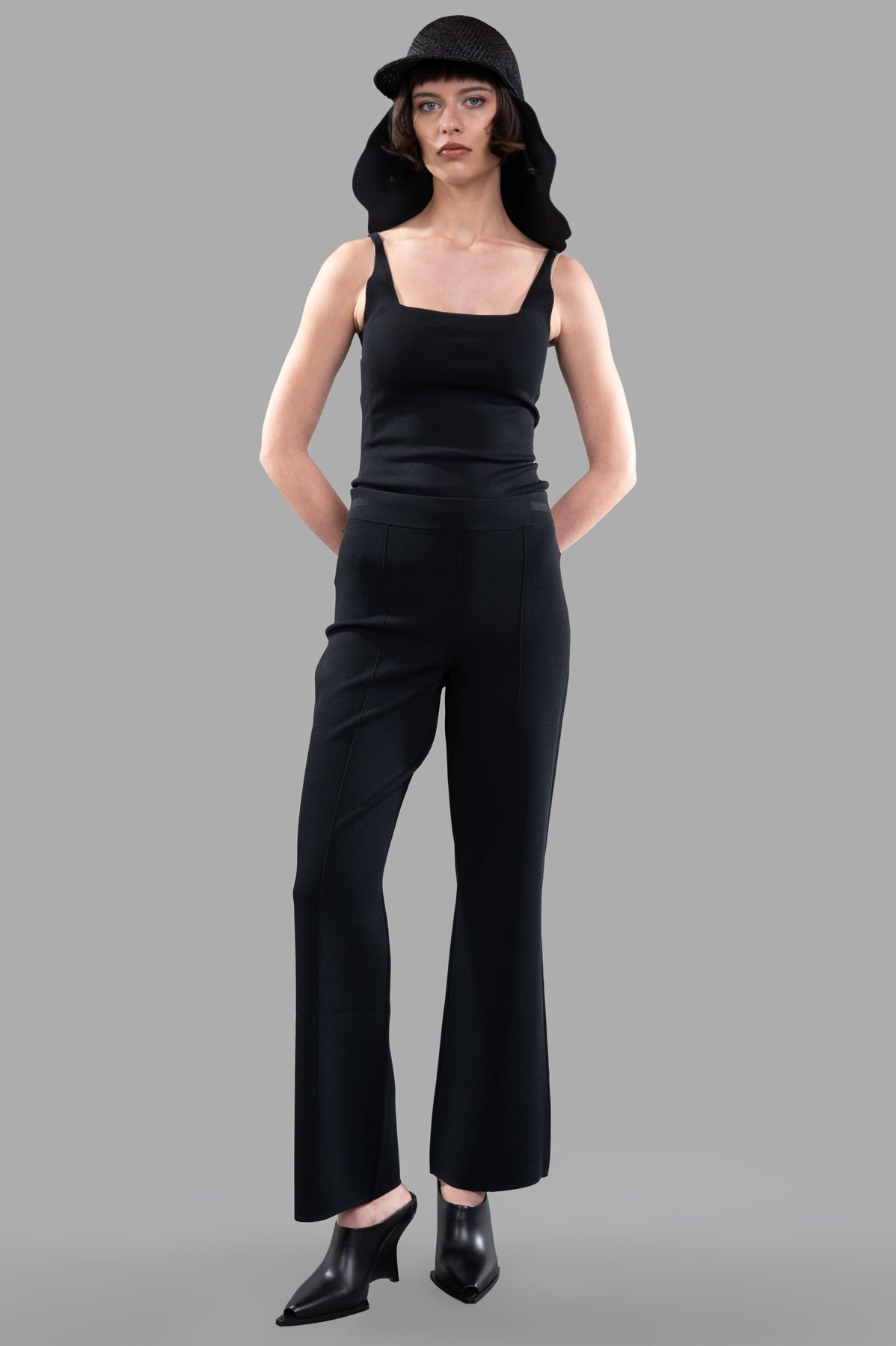 Joseph Stretch Knit Trousers, front view on model, black flared pants with elastic waistband, Milano stitch fabric.