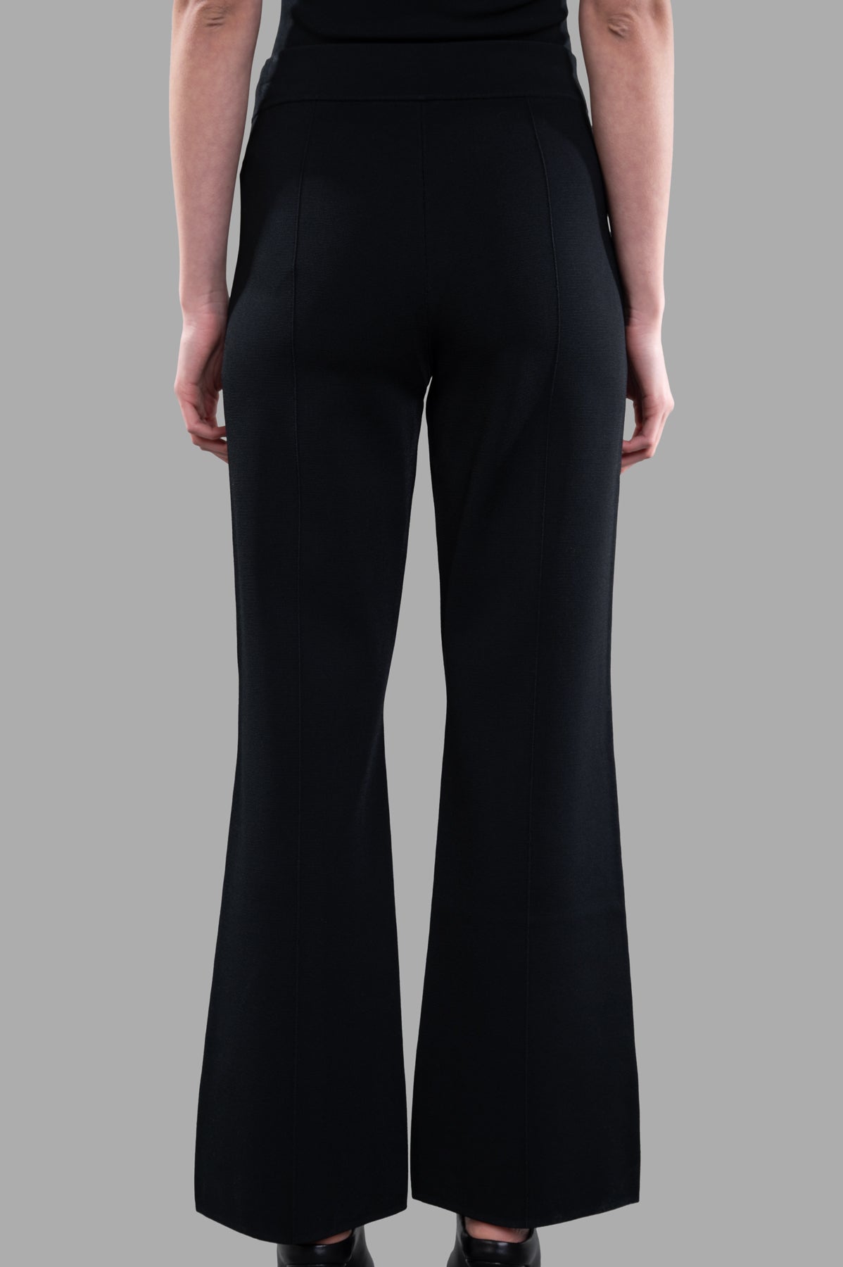 Joseph. Stretch Knit Trousers in black, showcasing the smooth back view with a flared silhouette and elasticized waistband.