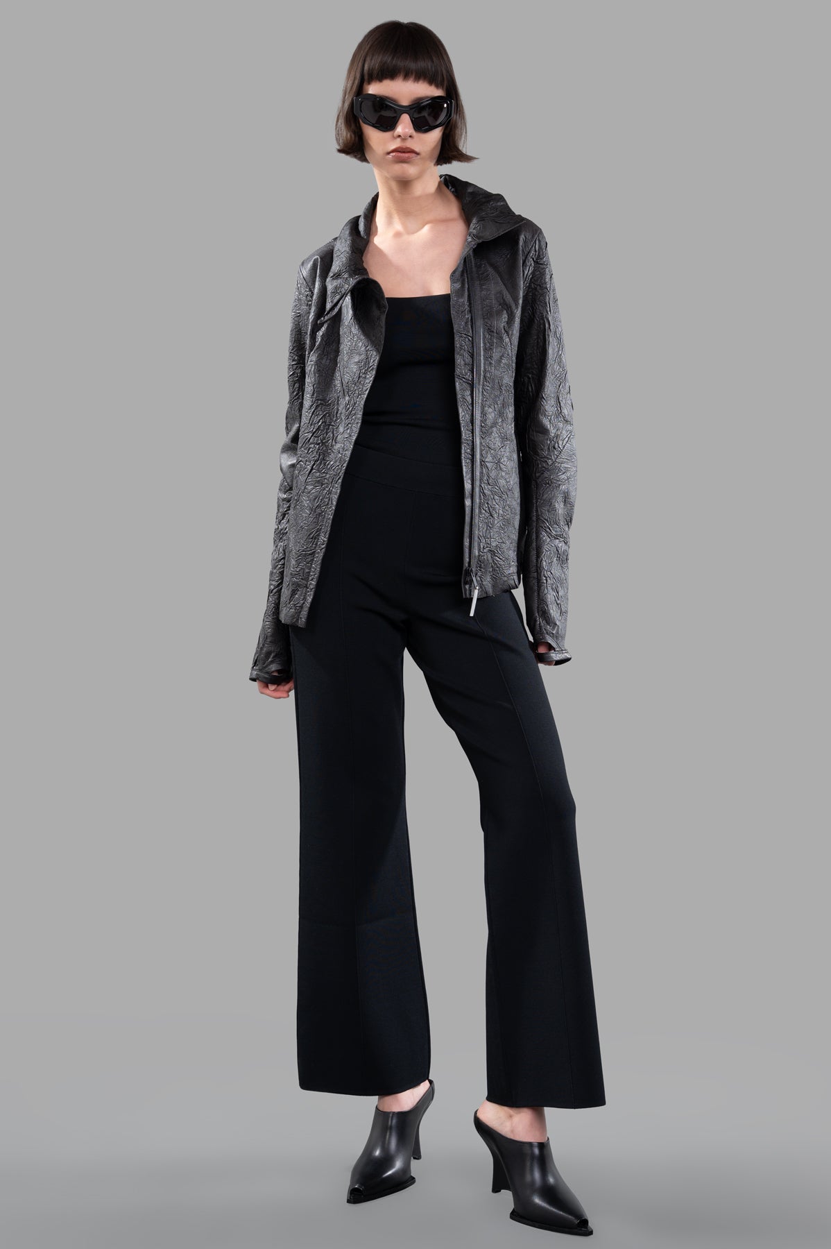 Isaac Sellam Crinkled Leather Jacket in black, front view on model, with concealed zip and stand-up collar, lambskin texture.