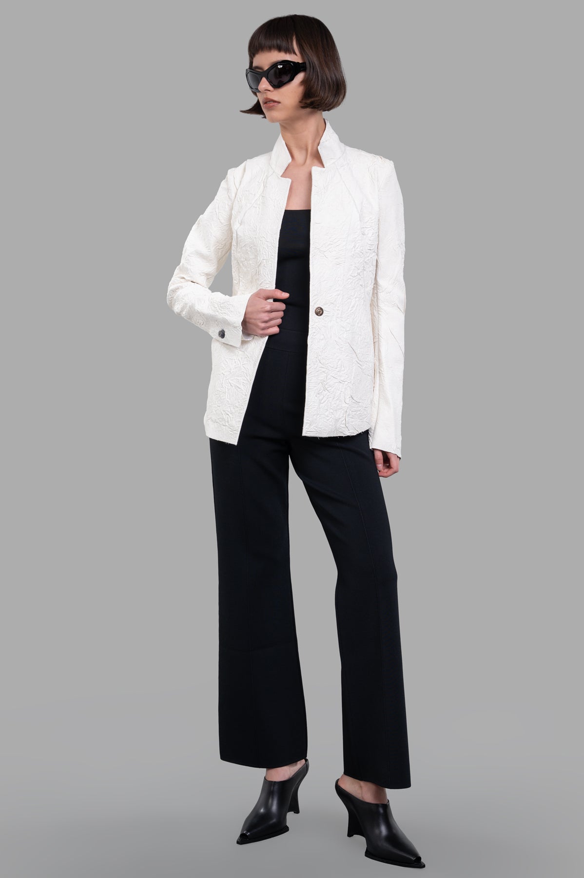 Isaac Sellam Fitted Leather Jacket in ecru, front view on model, showcasing hand-crafted texture and scalloped seams.