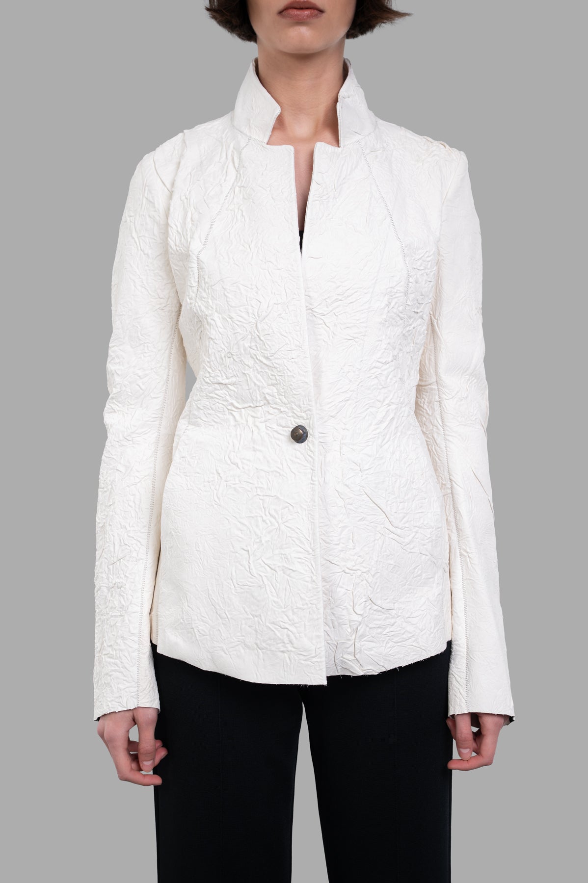 Isaac Sellam Fitted Leather Jacket in ecru; close-up of unique hand-crafted texture and buttoned front design.
