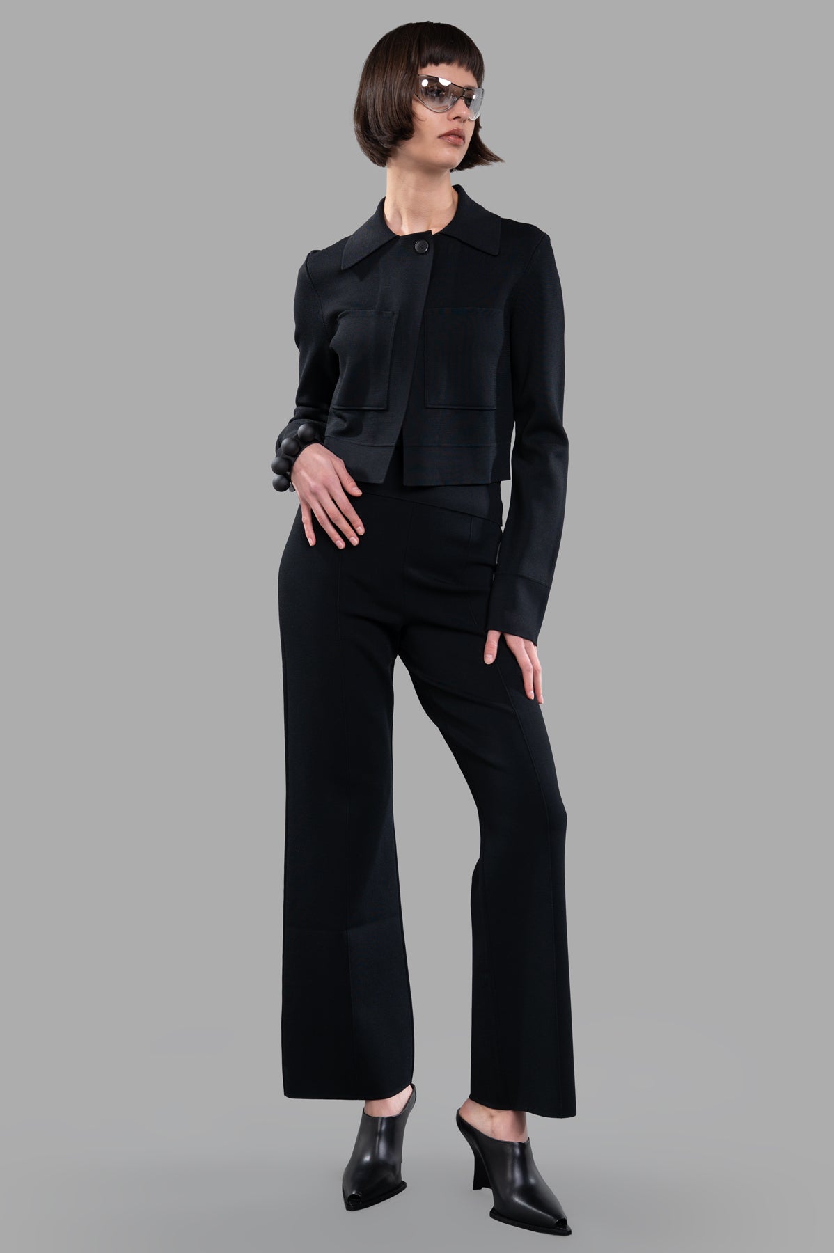 Joseph Stretch-zip Jacket in black, front view on model, featuring Milano knit with buttoned collar and boxy cut design.