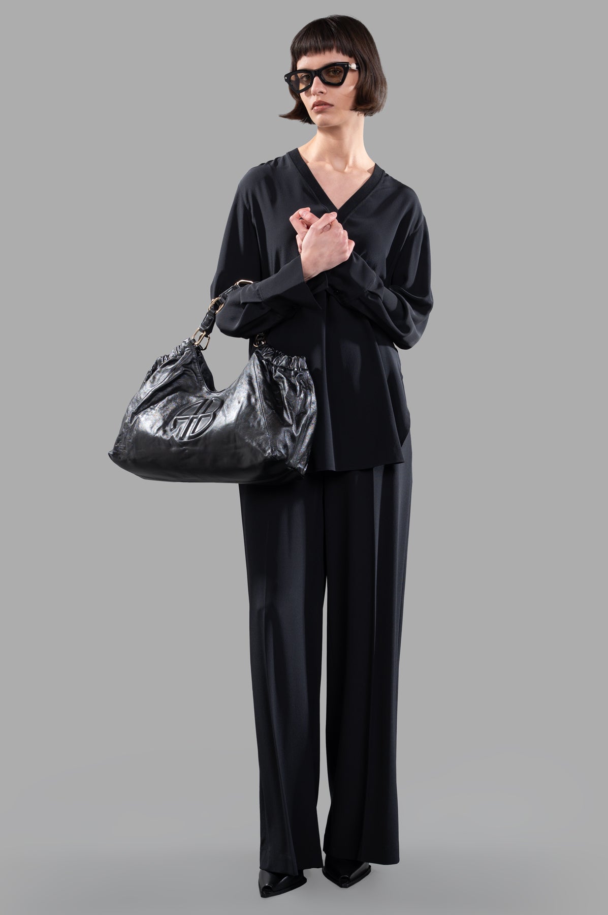 Joseph V-neck Silk Blouse in black, on-model front view, showcasing rib-knit neckline and elegant flowing fabric.