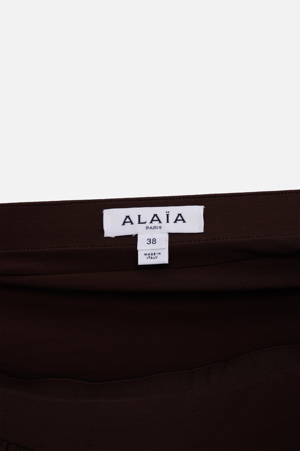 Alaïa women's ruffle skirt in brown, label detail with white size tag and smooth waistband