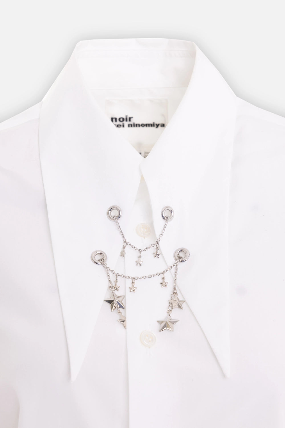 Noir Kei Ninomiya women's cotton shirt in white, collar detail, silver-tone star charms and eyelets
