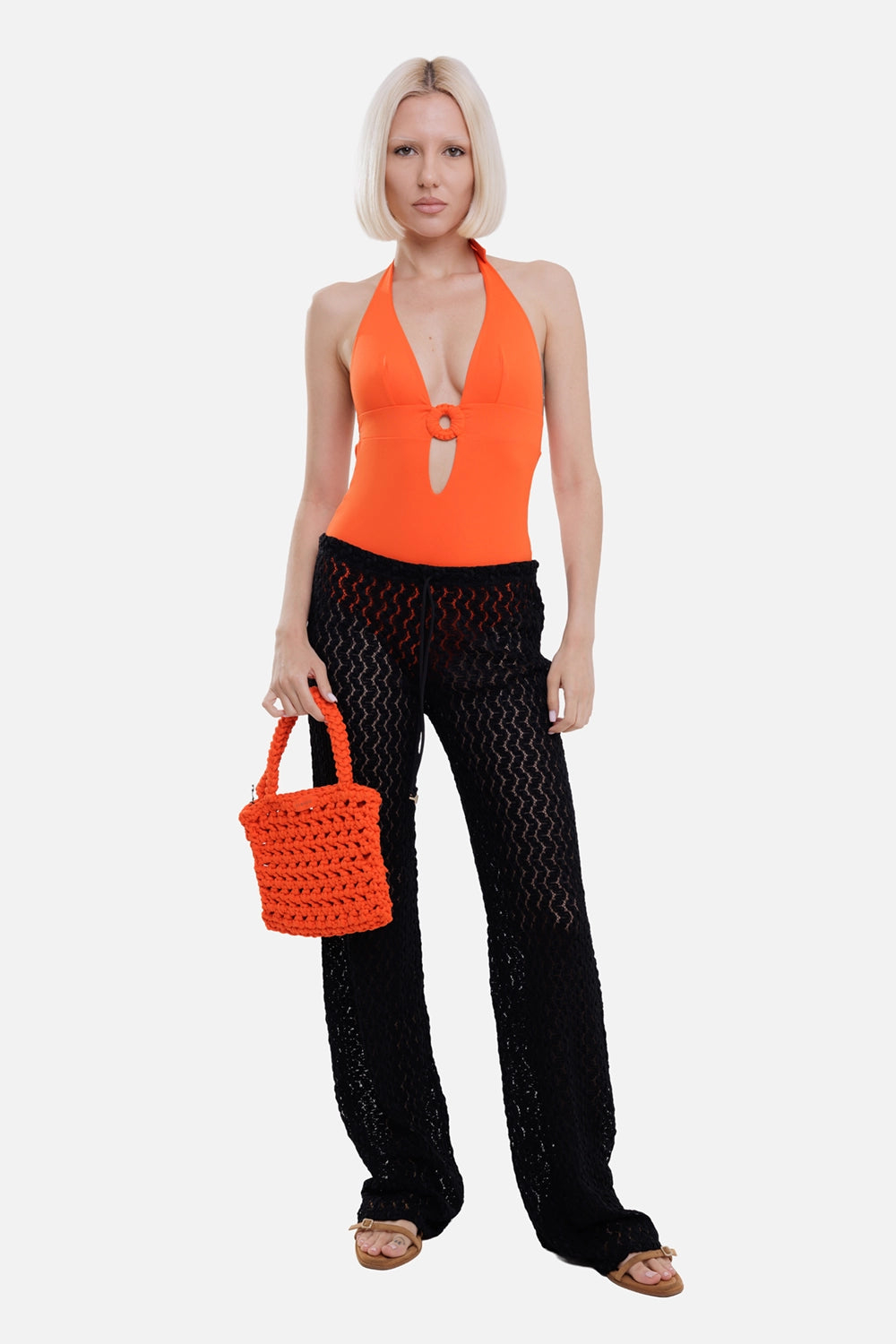 Fisico women's stretch lace pants in black, on-model full length, wide legs over orange swimsuit