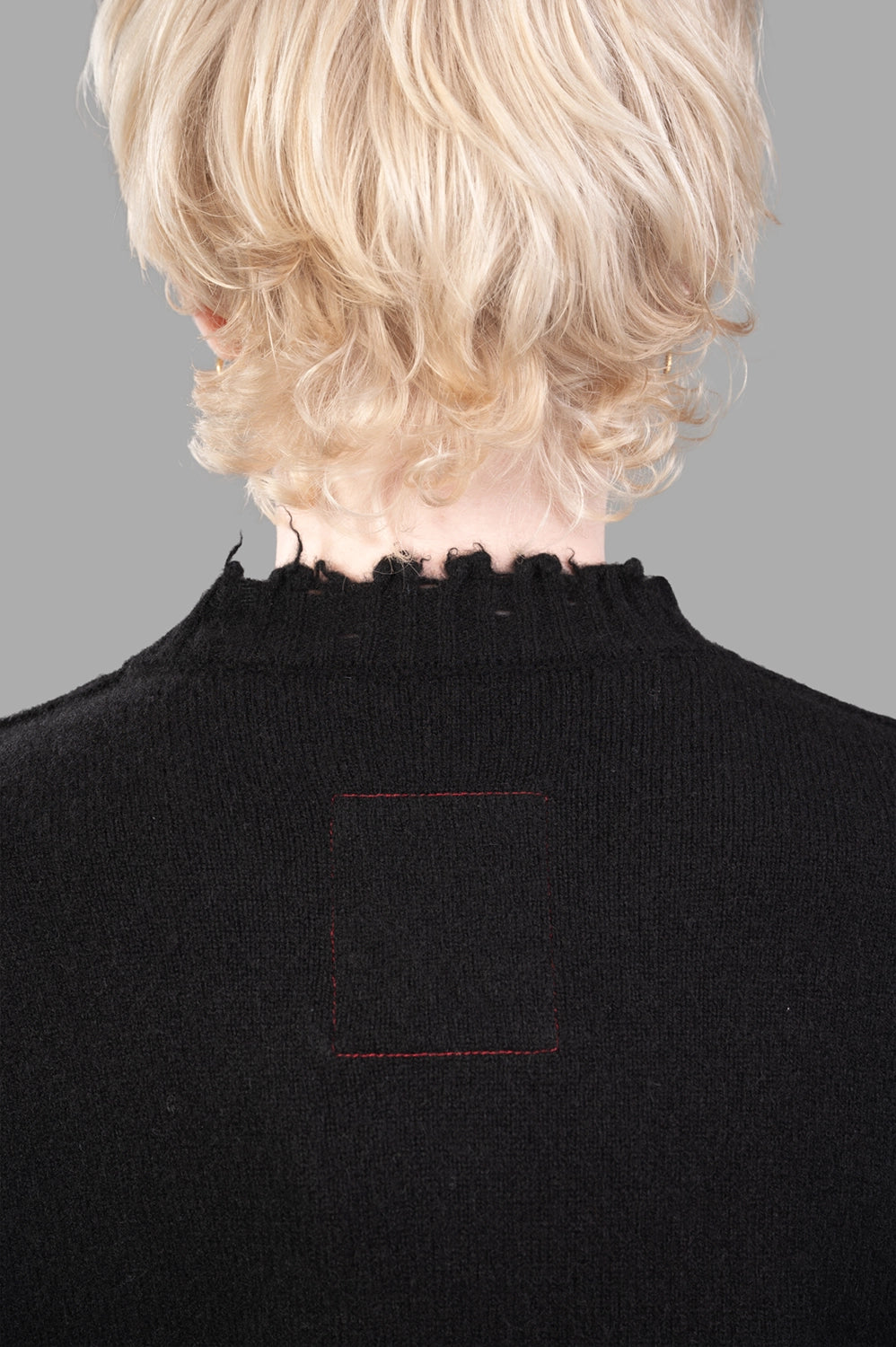 UMA WANG sweater in black, collar detail, red stitched back-neck patch and frayed ribbing