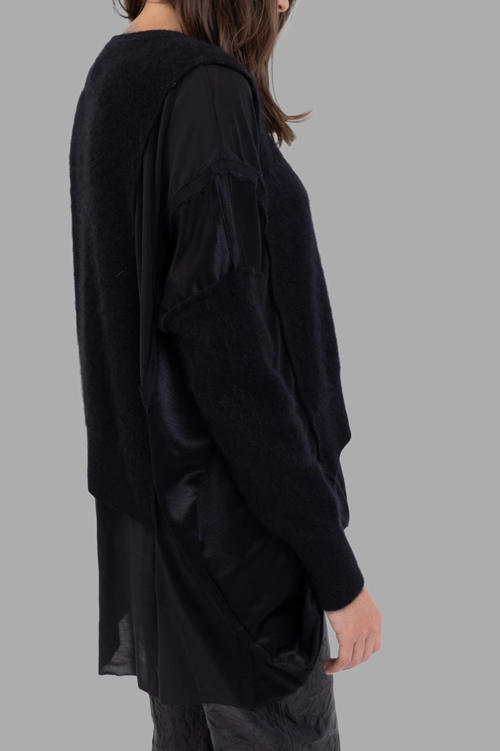 Giovanni Cavagna women layered knit sweater in black, side view, satin sleeve panels and raw-edge seams