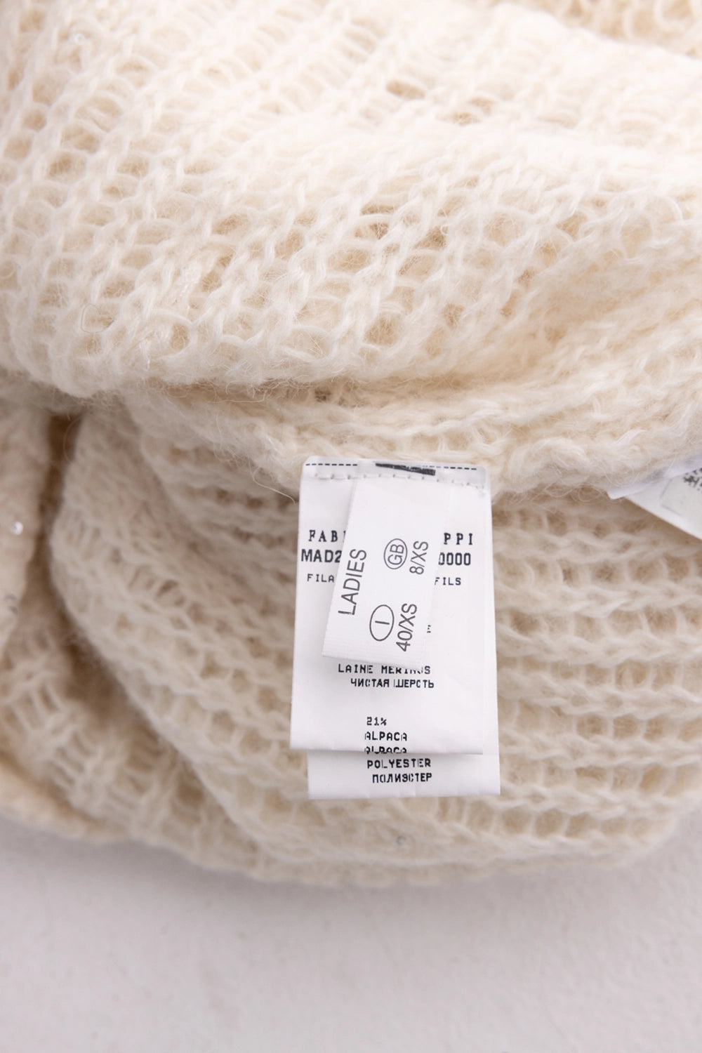 Pre-owned Fabiana Filippi women's sweater in ivory, care-tag view, inner label showing size XS