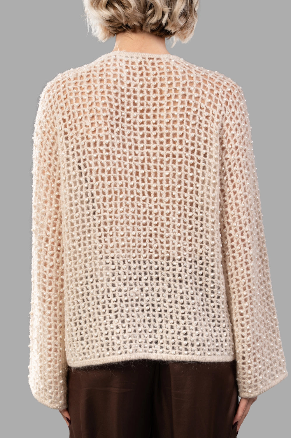 Back view of open-knit pearl sweater with relaxed fit and fine rib trims