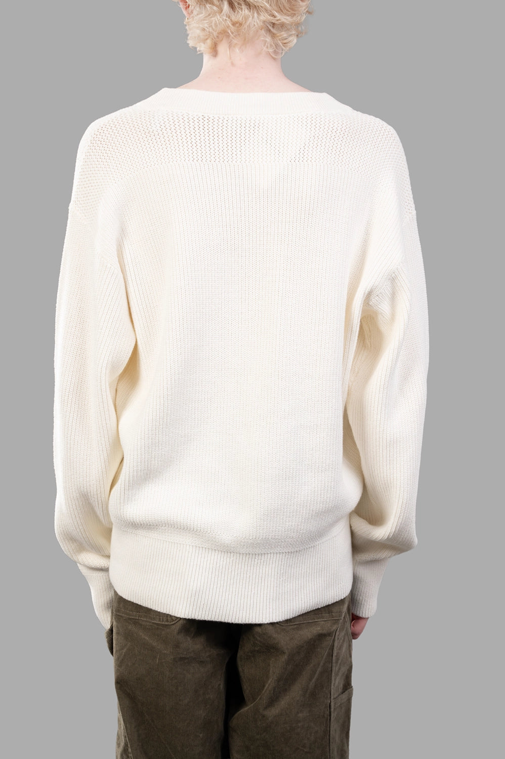 Back close-up of white ribbed sweater with textured yoke and ribbed hem