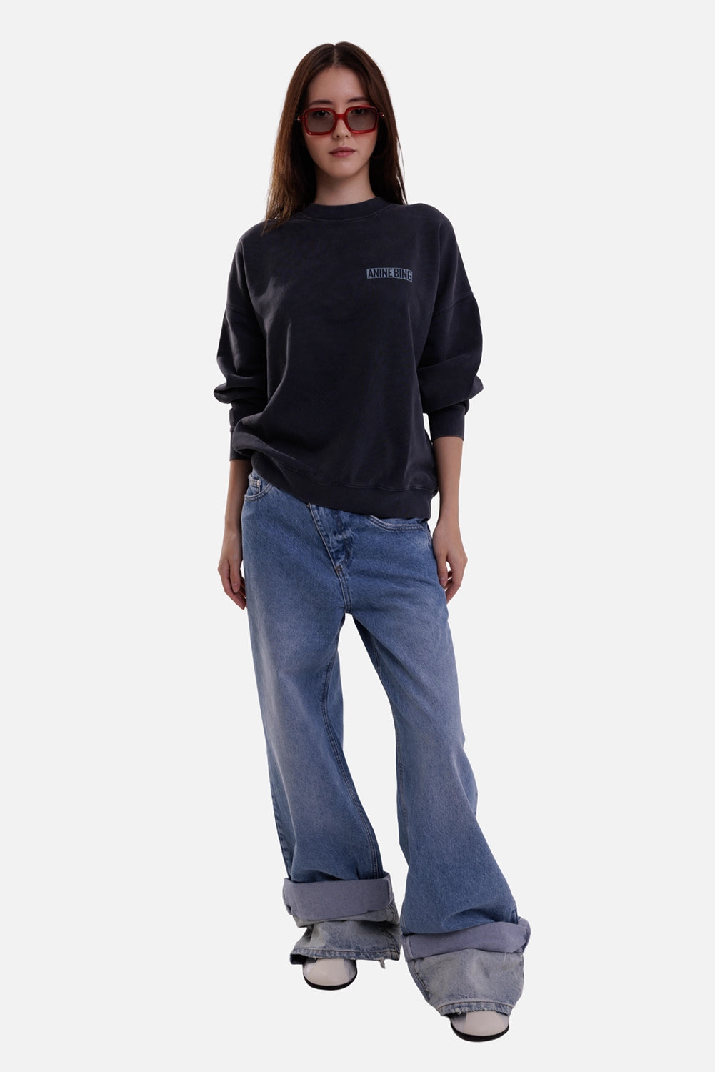 Anine Bing women's sweatshirt in washed black, full-length model view with small chest logo and oversized sleeves