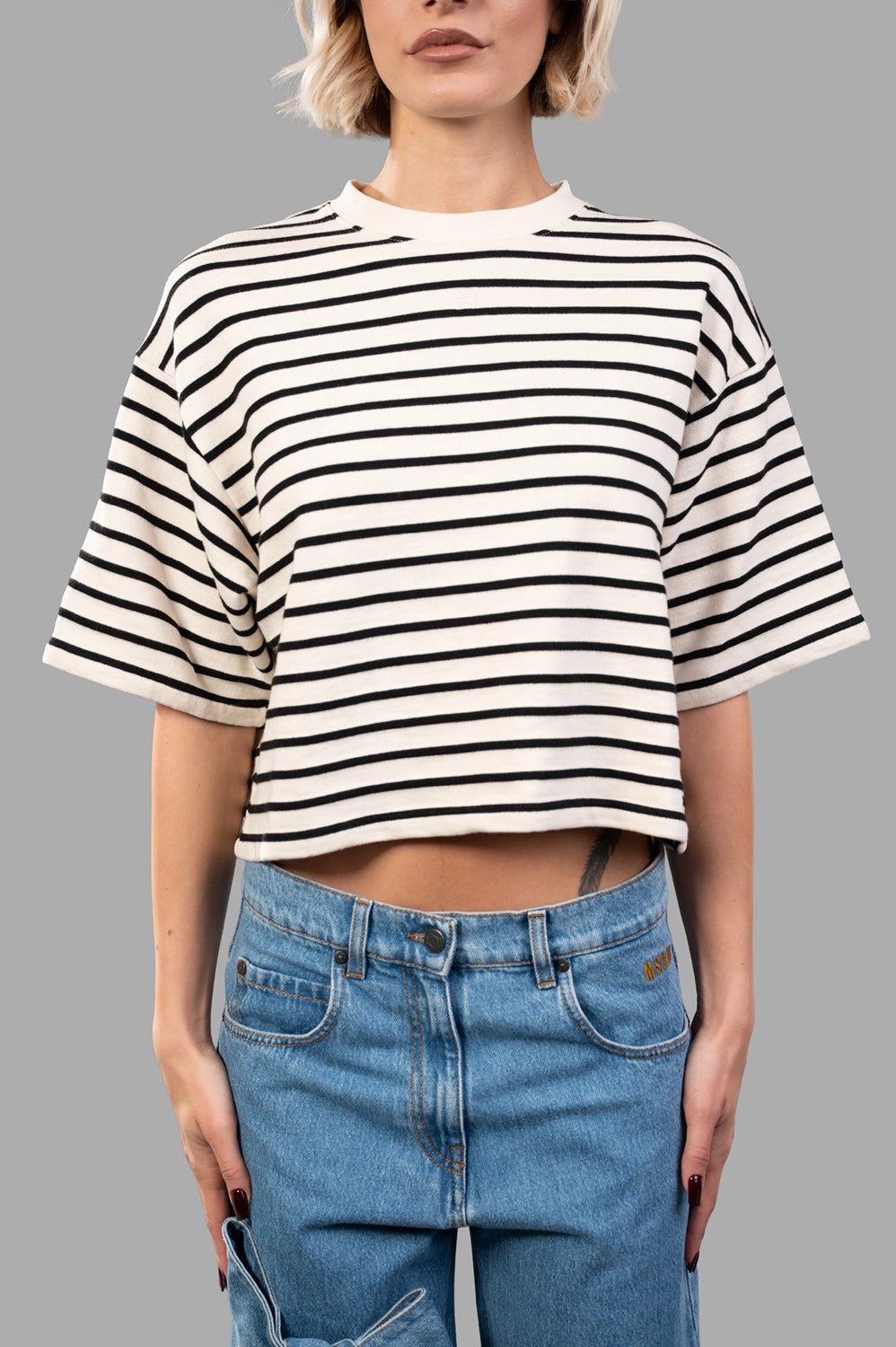 Front close‑up of striped French terry tee, showing texture and monogram detail