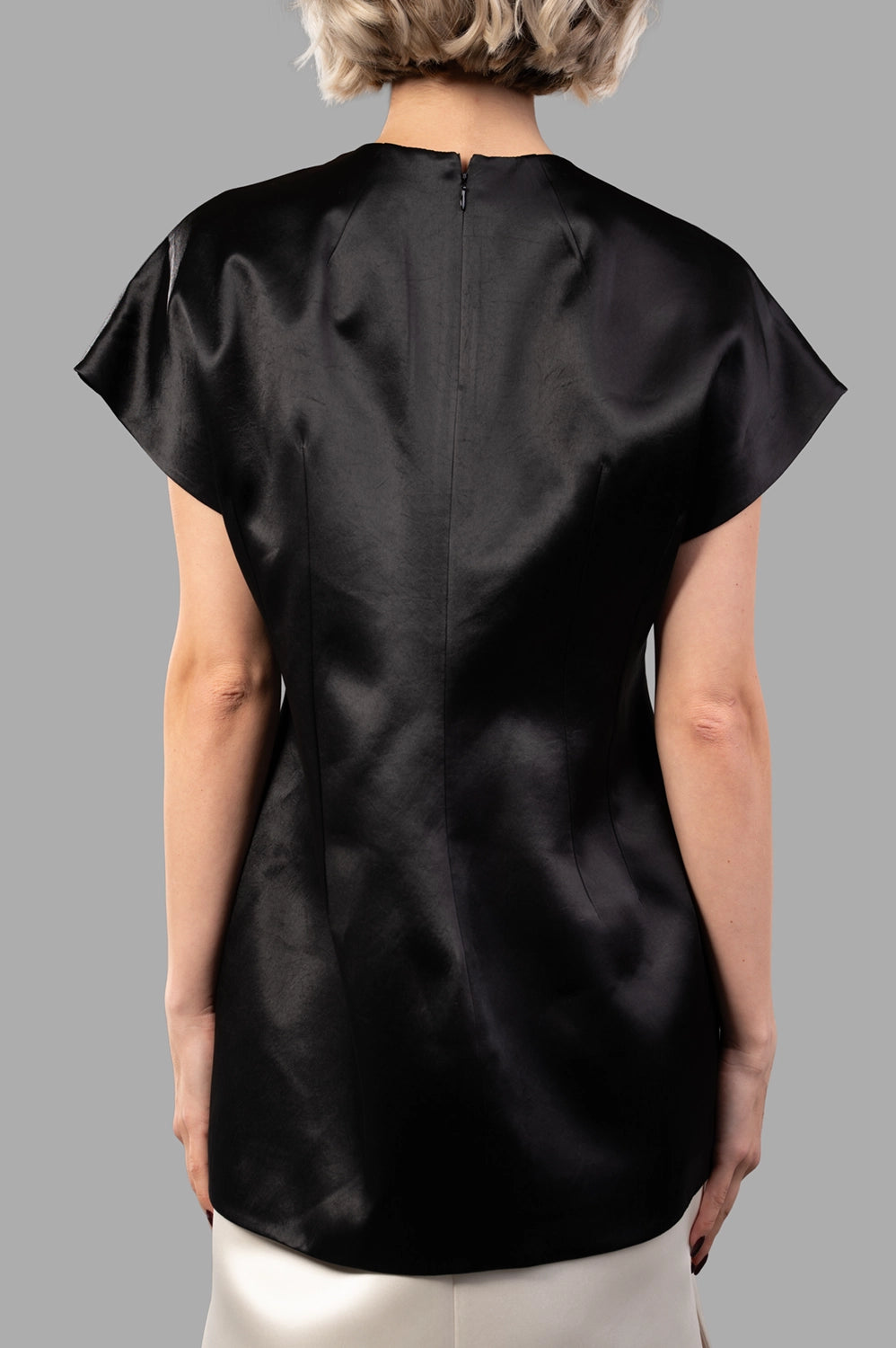 Back close-up of black satin top with concealed zip and clean panel seams