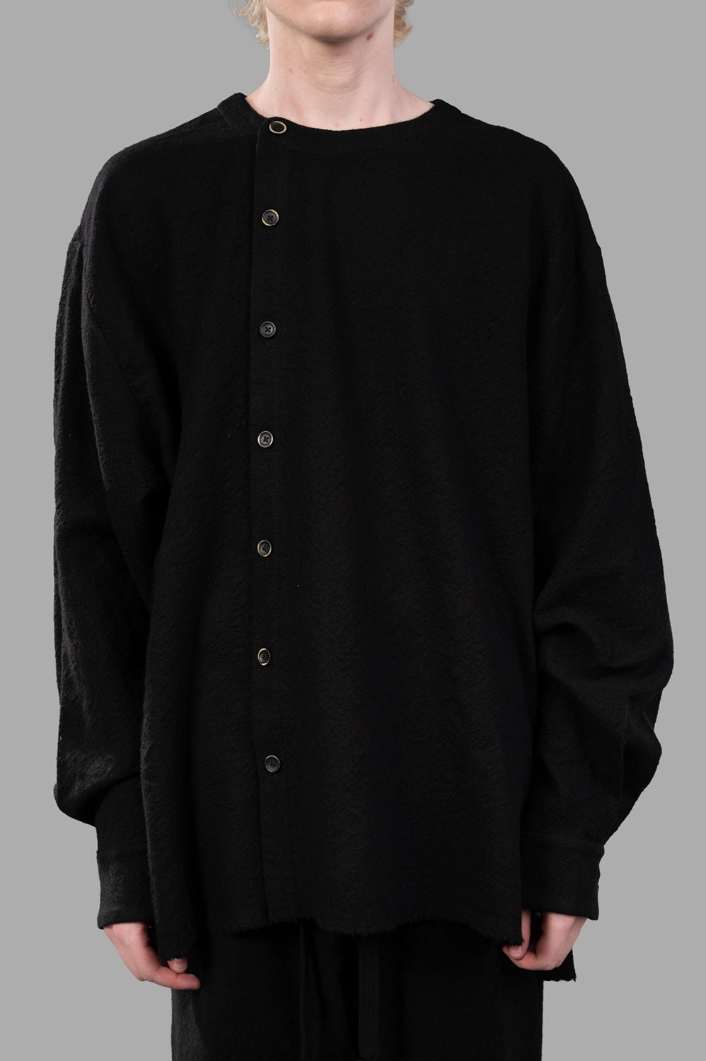 UMA WANG top in black, front view showing asymmetric button column and dropped shoulders