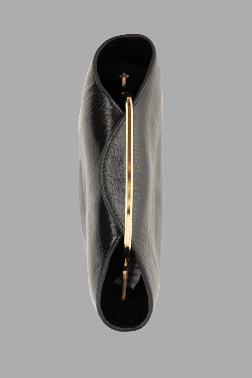 GentryPortofino women's top-handle bag in Nero, side view, slim gold top handle and curved opening.