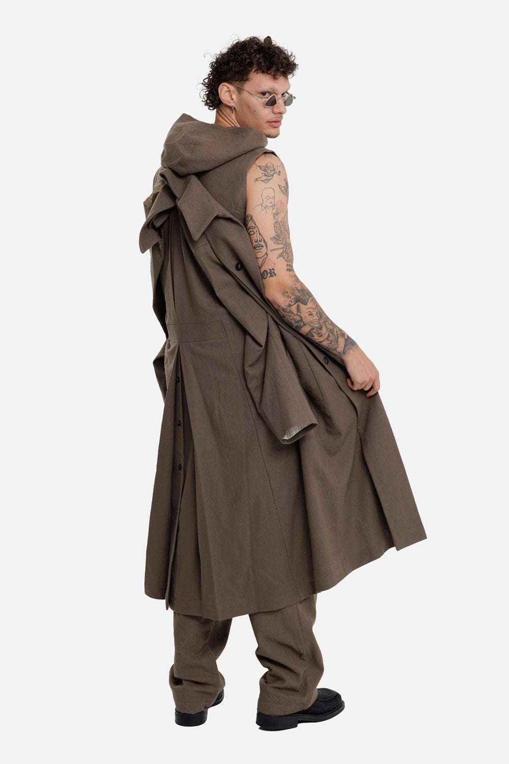 Masnada men's trench coat in Marsh, on-model rear three-quarter view with hooded layered construction