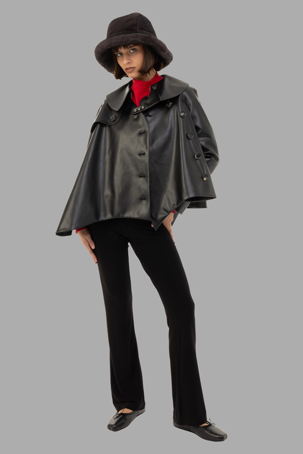 A.W.A.K.E. MODE women's trench jacket in black, full length on model, flared cape silhouette
