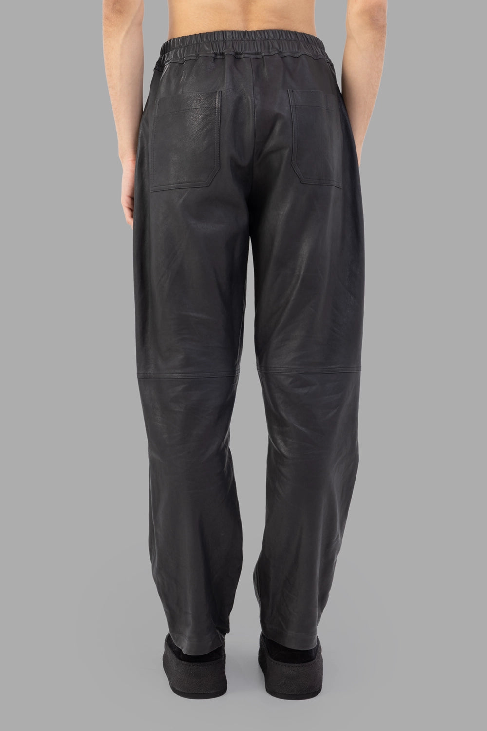 AION leather trousers in black, front view close, knee seam panels visible