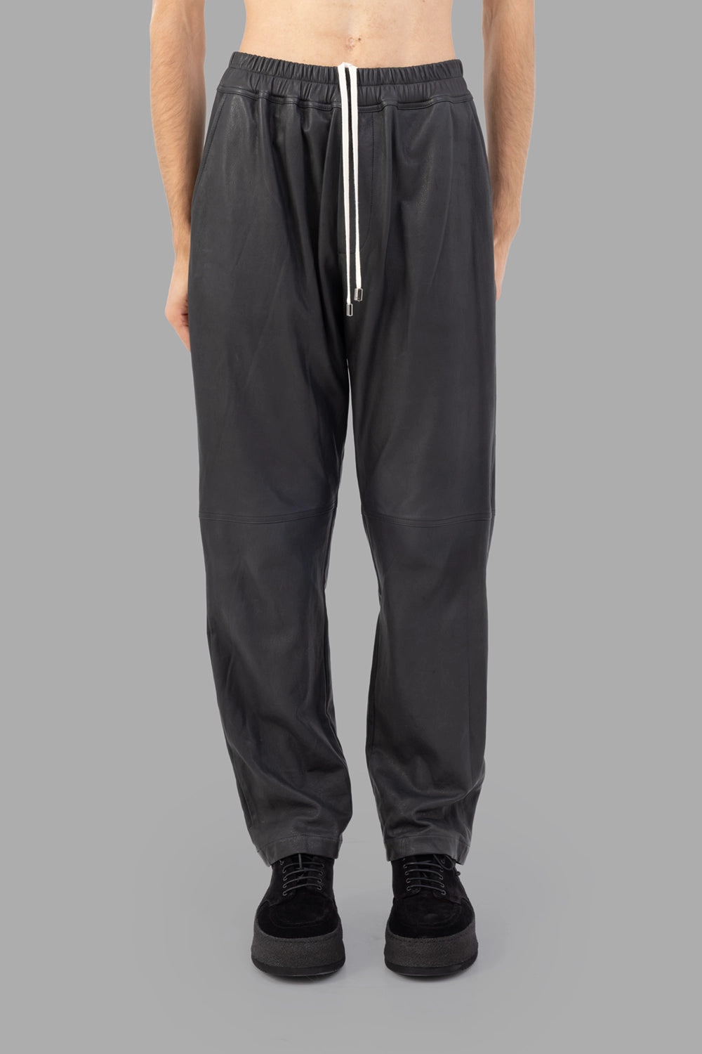 AION leather trousers in black, front view, elastic waist with long drawstrings