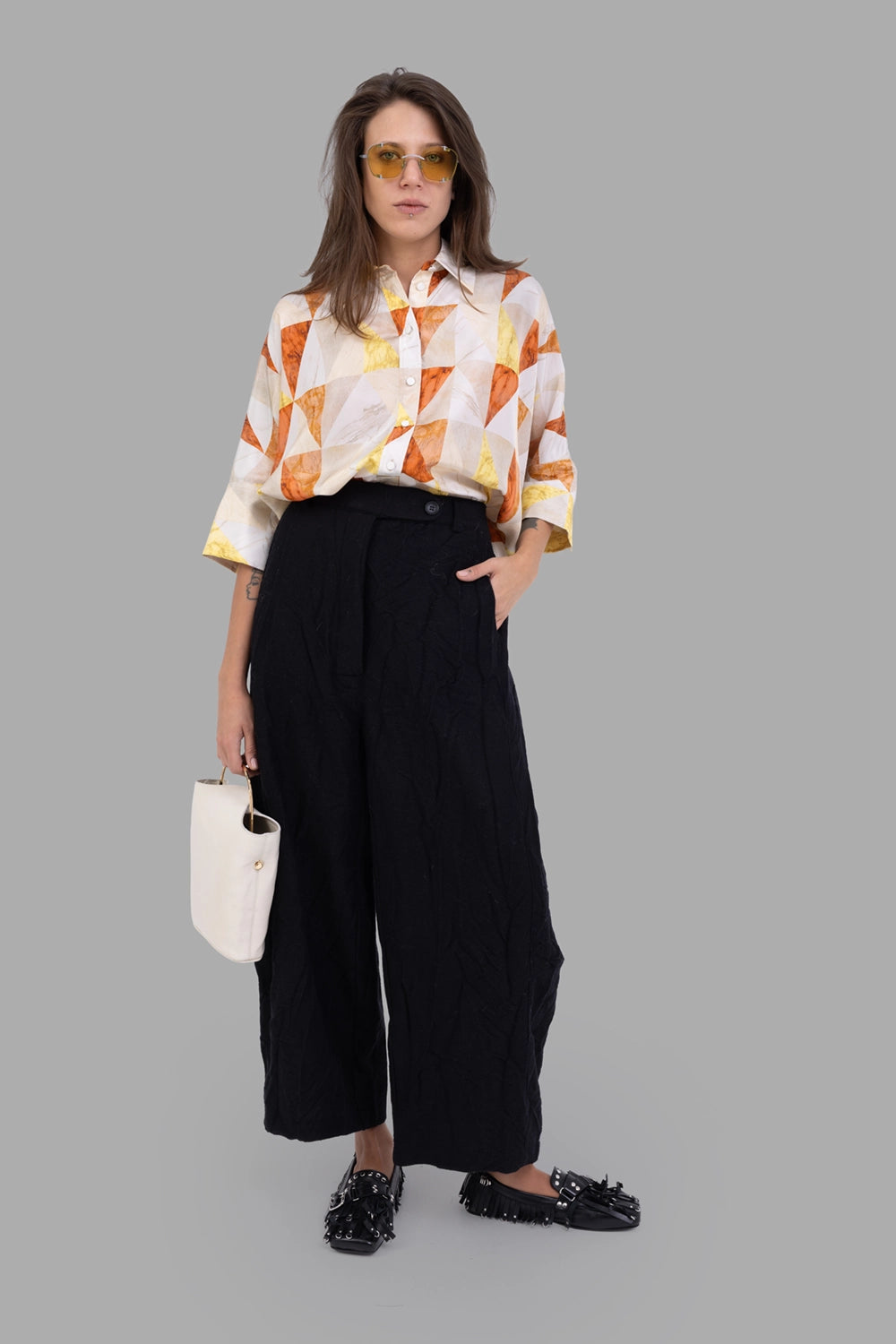 Marc Point women's wide-leg trousers in black, on-model full length, crinkled texture and offset waist button