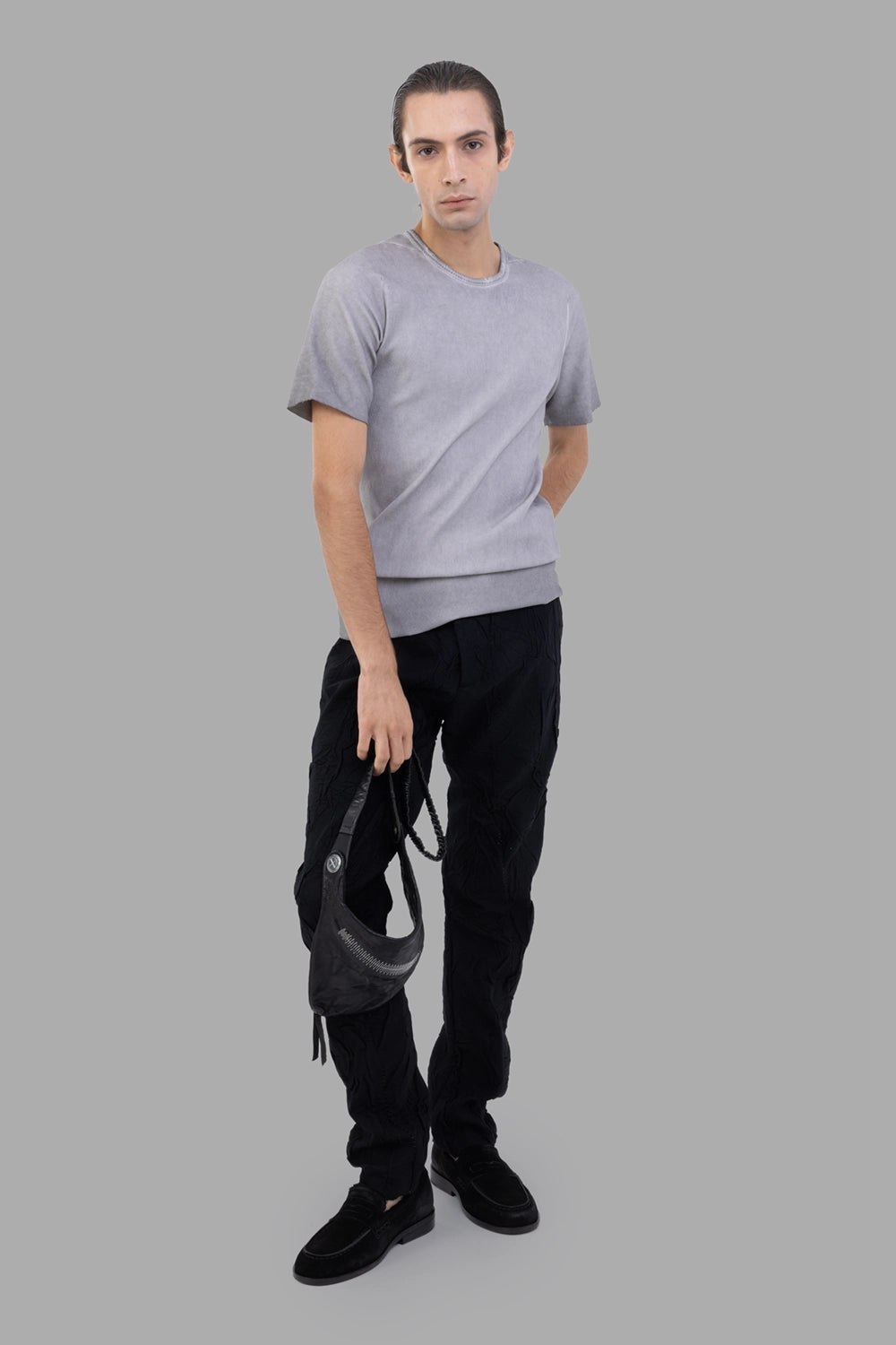 Masnada slim trousers in black, on-model full length, crinkle texture and slim leg