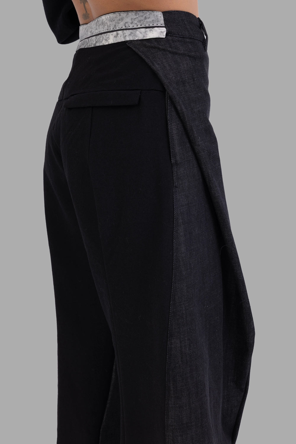 Giovanni Cavagna women's trousers in black, side view, contrast wrap panel and marbled waistband detail