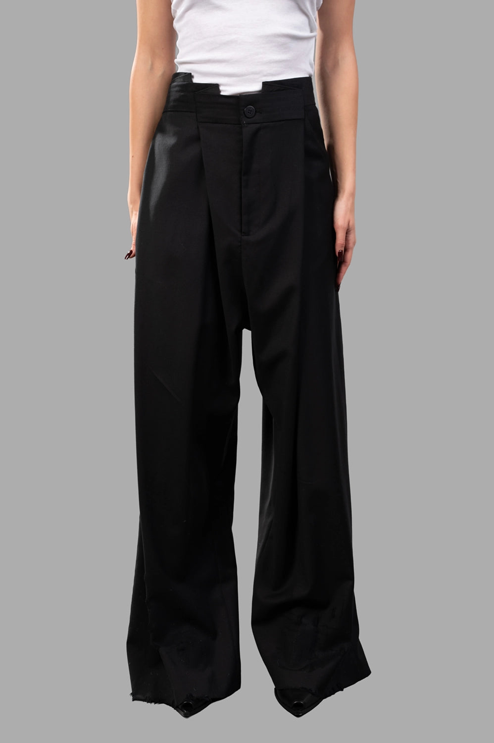 Natasha Zinko trousers in black wool, front view, folded waistband and button closure