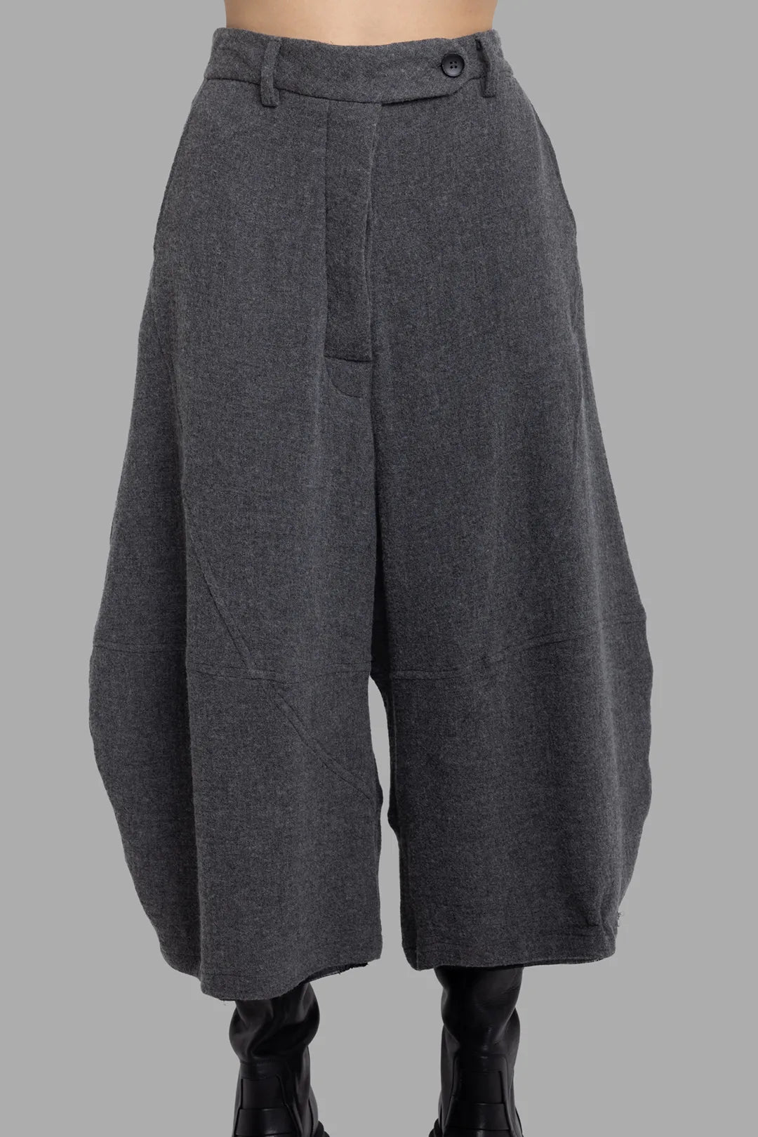 Marc Point unisex charcoal grey trousers, front close-up showing asymmetric waistband and dropped crotch.
