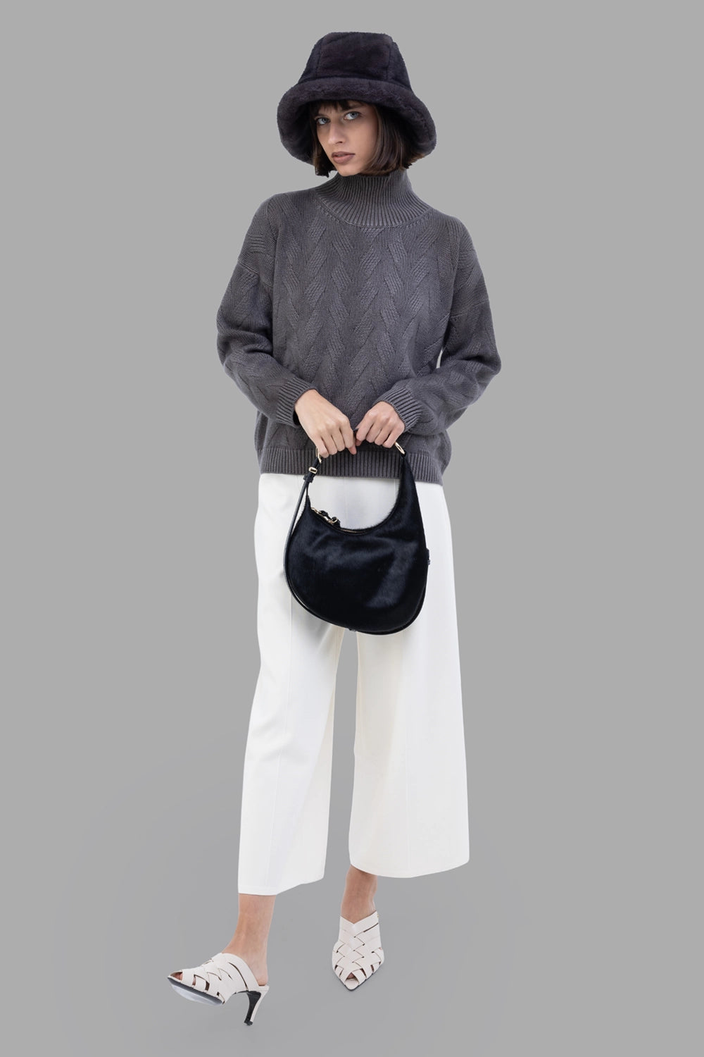 GentryPortofino women's turtleneck sweater in Mastice, full-length on model, chevron knit and ribbed high neck