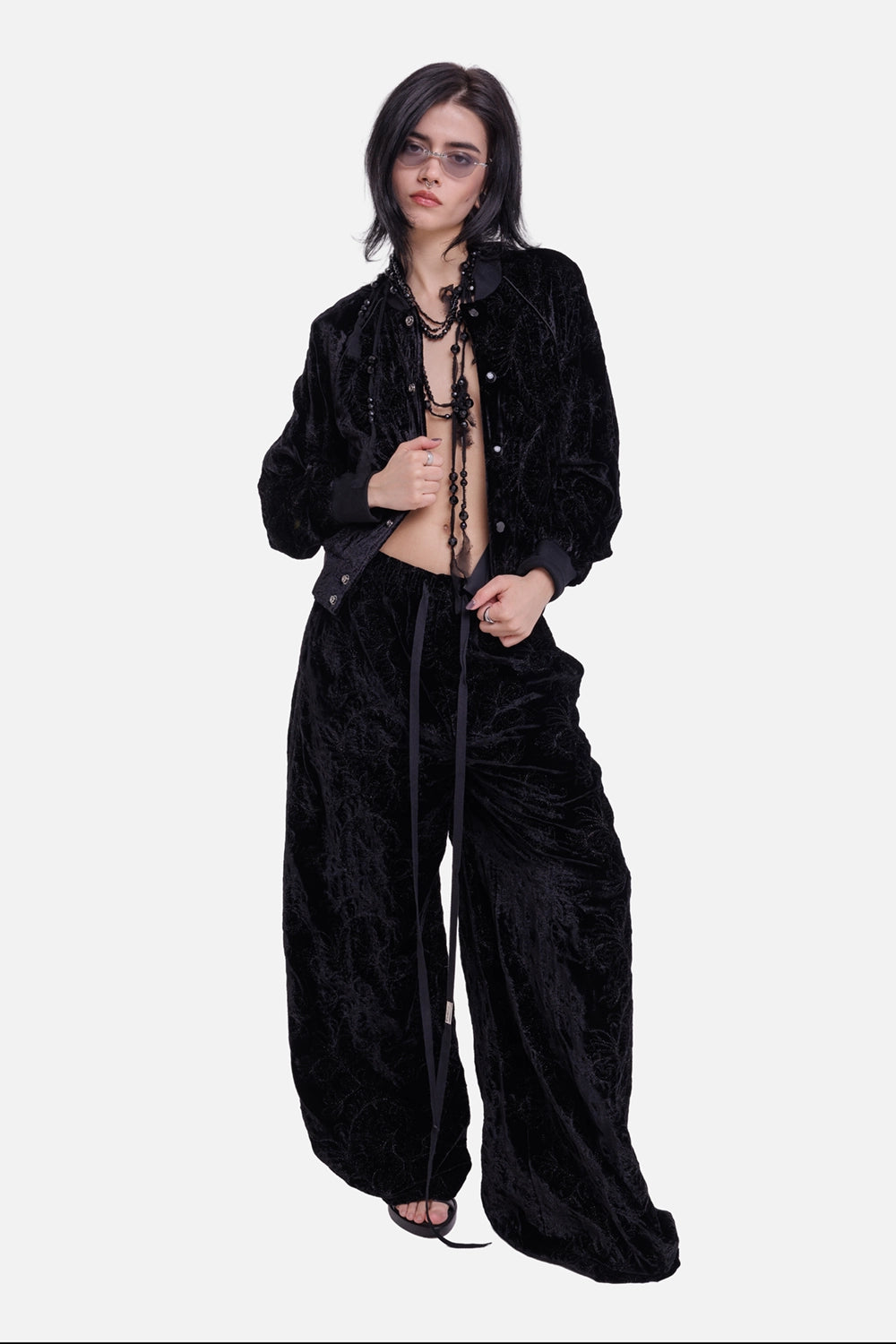 Ann Demeulemeester women's black velvet bomber jacket, full-length model view with paisley texture and snap front