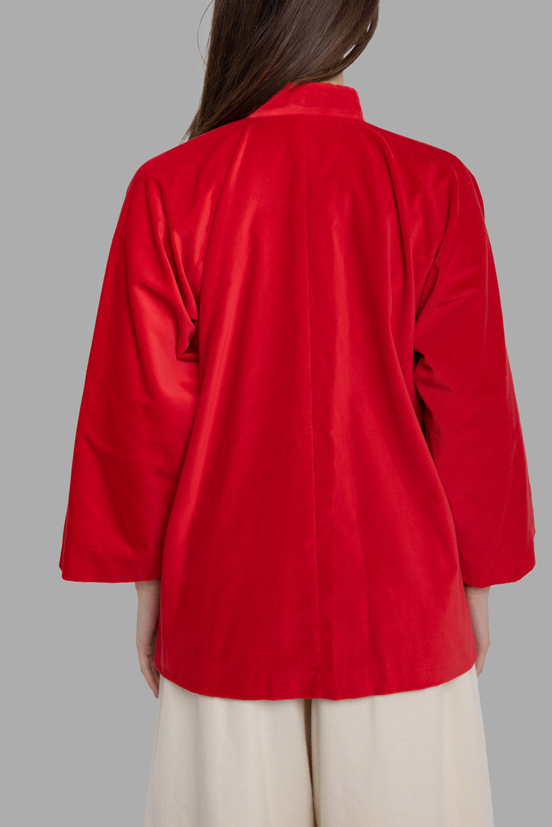 Comme des Garçons women's red velvet jacket, back view showing clean seams and softly draped hem.