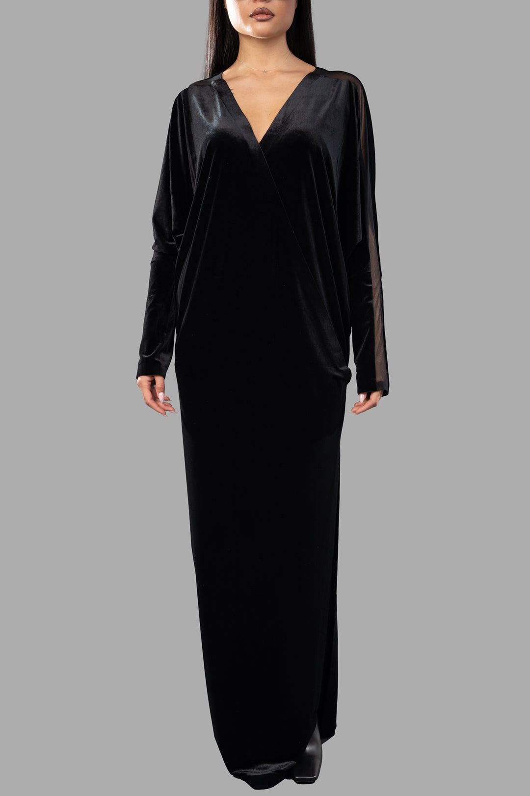 Norma Kamali Dolman Wrap Gown in black, featuring long sleeves, v-neckline, and elegant side slit for formal occasions.