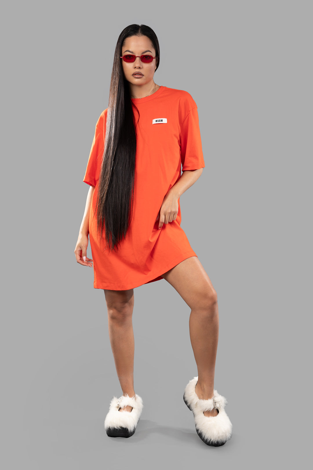 MSGM Orange T-shirt Dress in cotton, front view on model, featuring logo detail and oval open back design.