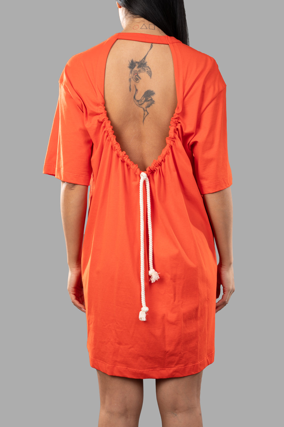 MSGM Orange T-shirt Dress featuring a unique oval open back design and drawstring detail, crafted from soft 100% cotton.