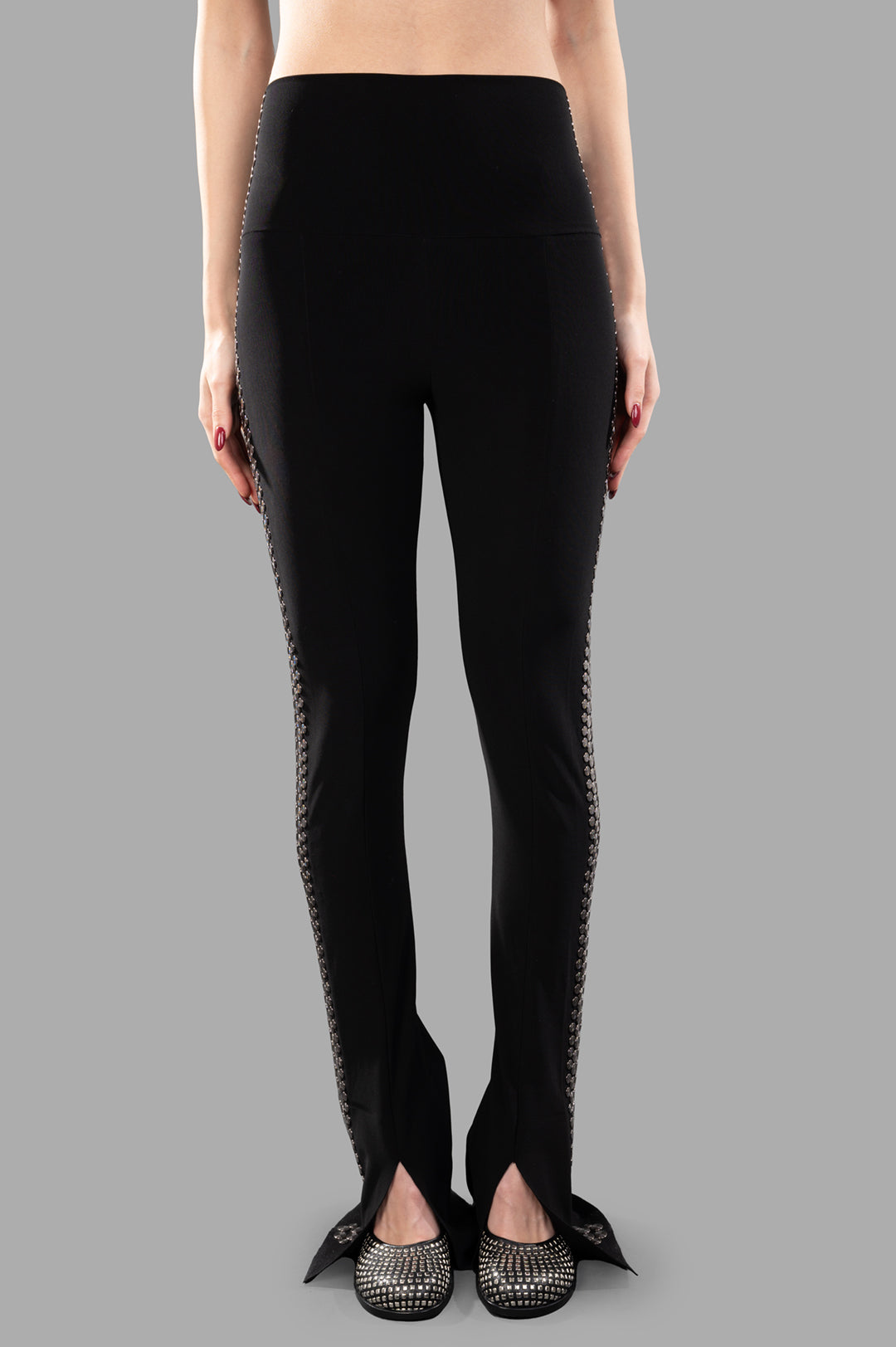 Norma Kamali Stud Spat Legging shown in black with silver studs, featuring a slim fit and high waist design on a model.