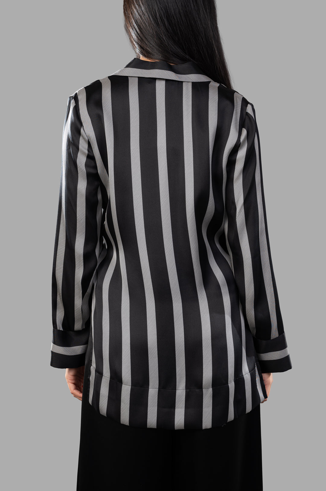 Anine Bing Lynette Shirt showcases the back view with black herringbone stripes and a luxurious silk blend.