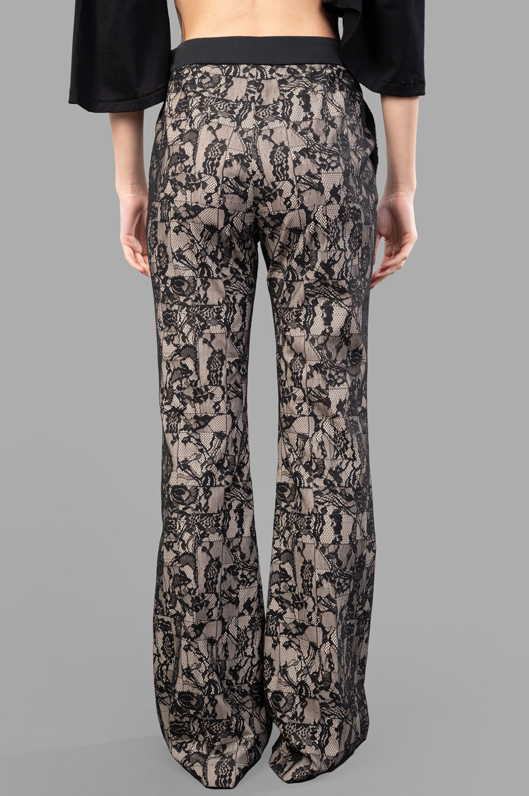 Joseph Patchwork Lace Trousers showcasing a deconstructed lace pattern from the back, highlighting fluid fit and modern.