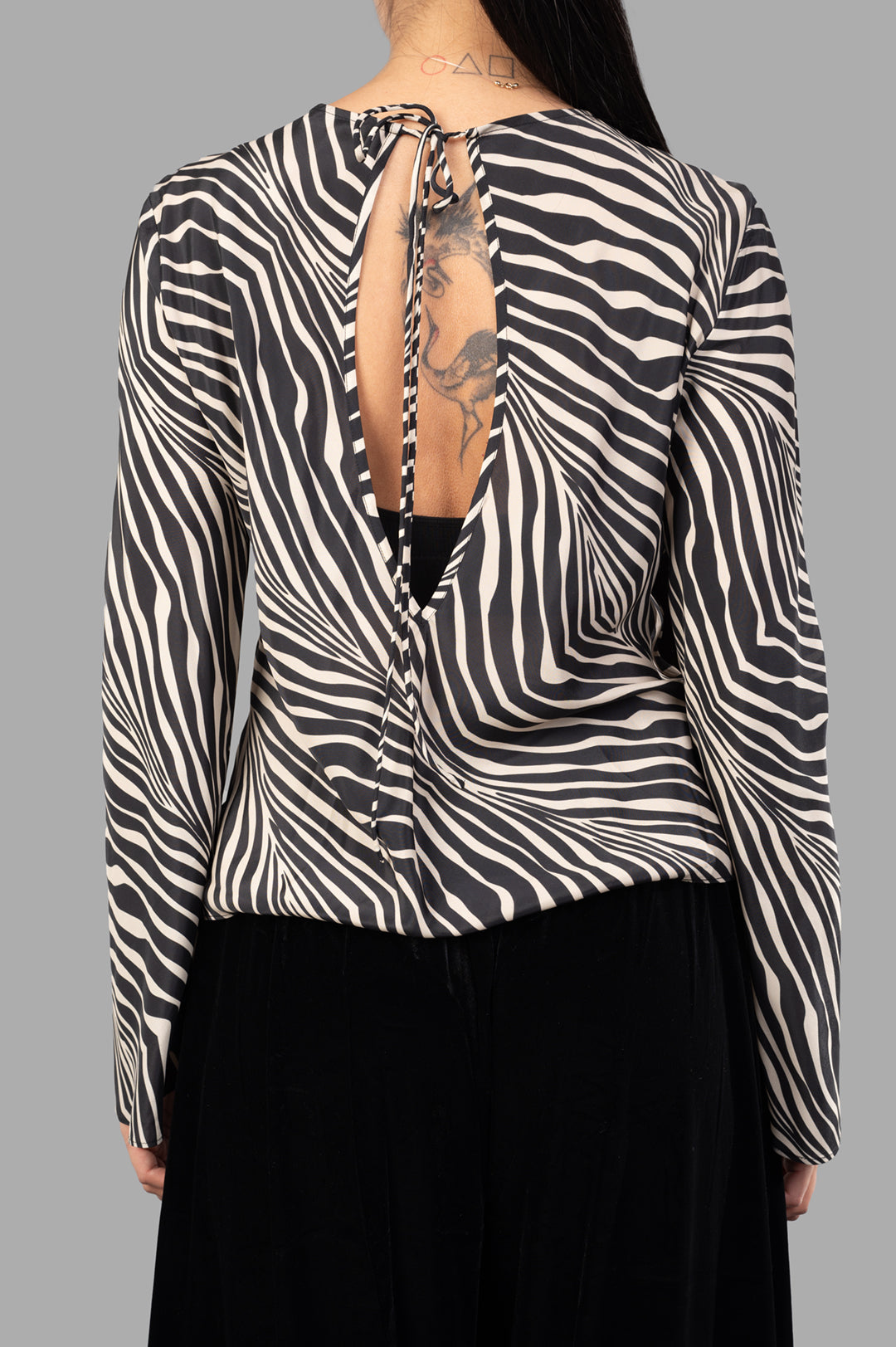 By Malene Birger Pricilla Top features a low back, ties at neck, and zebra print, showcasing the silk-blend fabric detail.