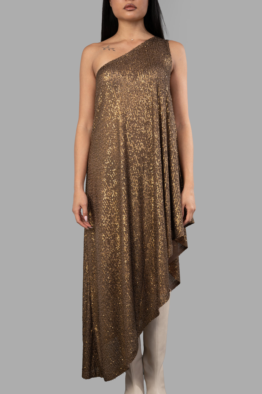 Norma Kamali one-shoulder diagonal tunic in bronze, featuring all-over sequins and an asymmetrical hem, on model.