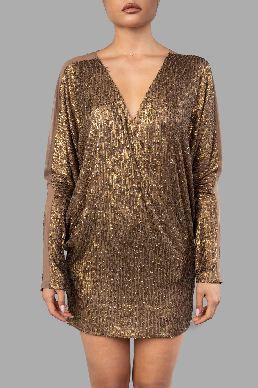 Norma Kamali Dolman Wrap Mini Dress in bronze with sequins, featuring a v-neckline and Dolman sleeves for a relaxed fit.