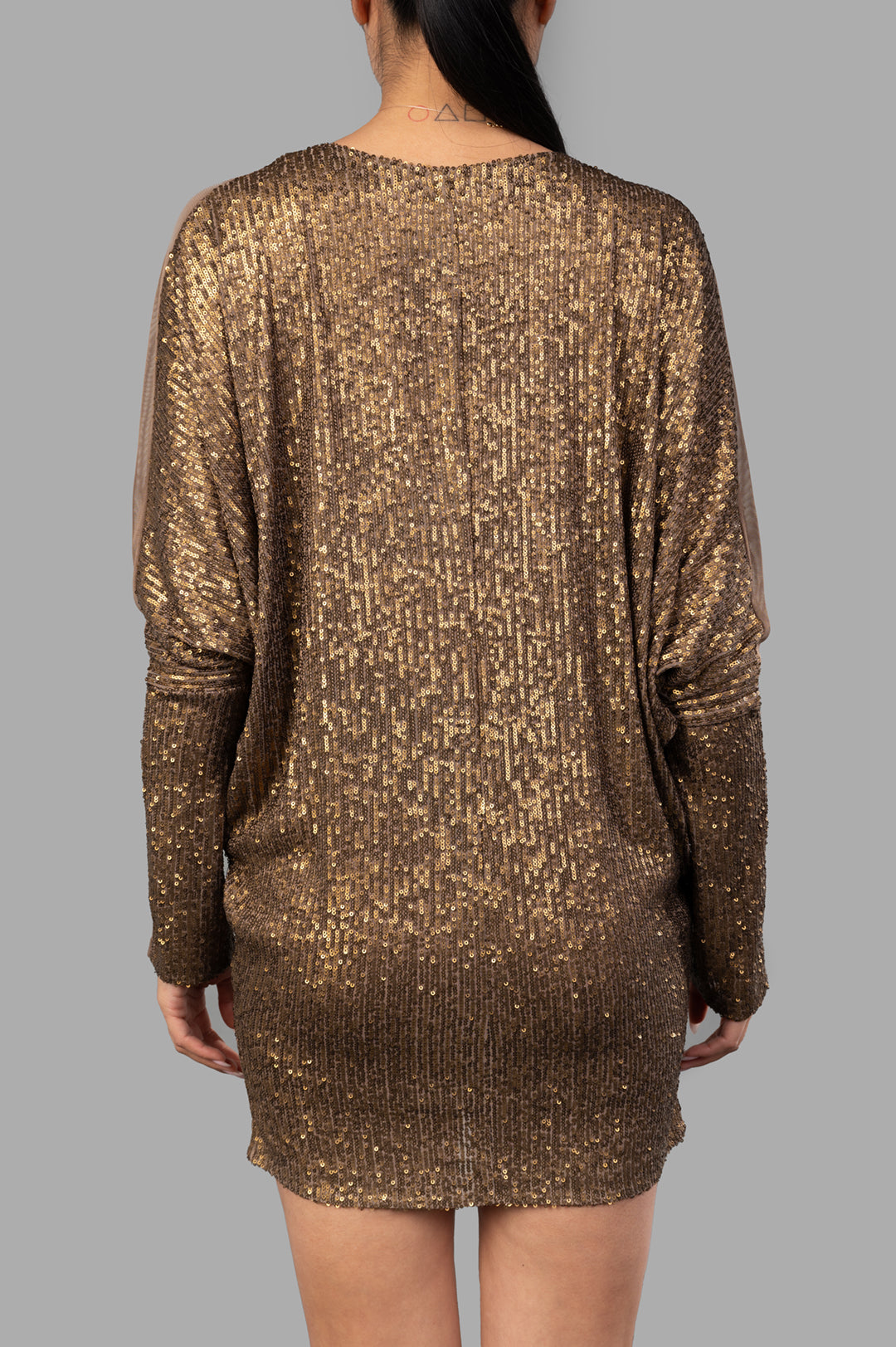 Norma Kamali Dolman Wrap Mini Dress showcasing the back view with sequins and dolman sleeves in bronze color.