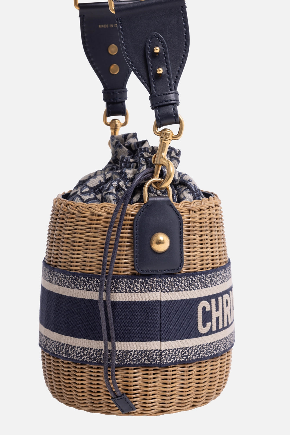 Pre-owned Christian Dior wicker bucket bag in natural and navy, side detail view, gold-tone clasp and leather trim.