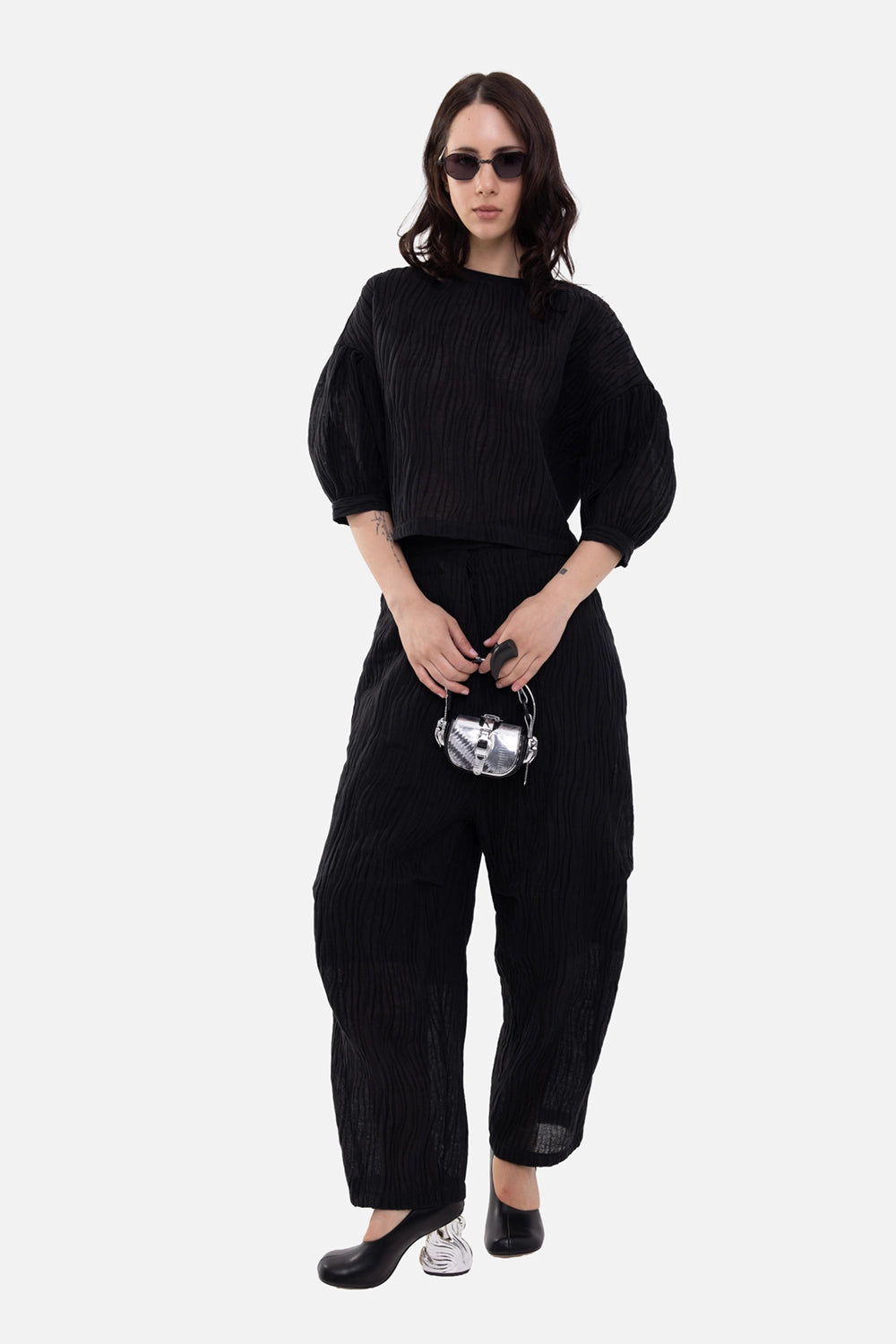 Marc Point women's trousers in black, on-model full-length view, wavy texture and cropped wide leg