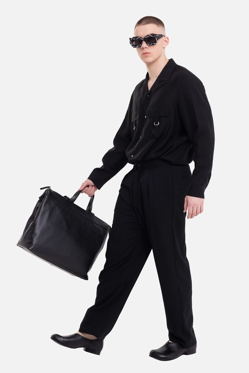 ATTACHMENT men's trousers in black, on-model full-length view with relaxed taper and drawstring waist